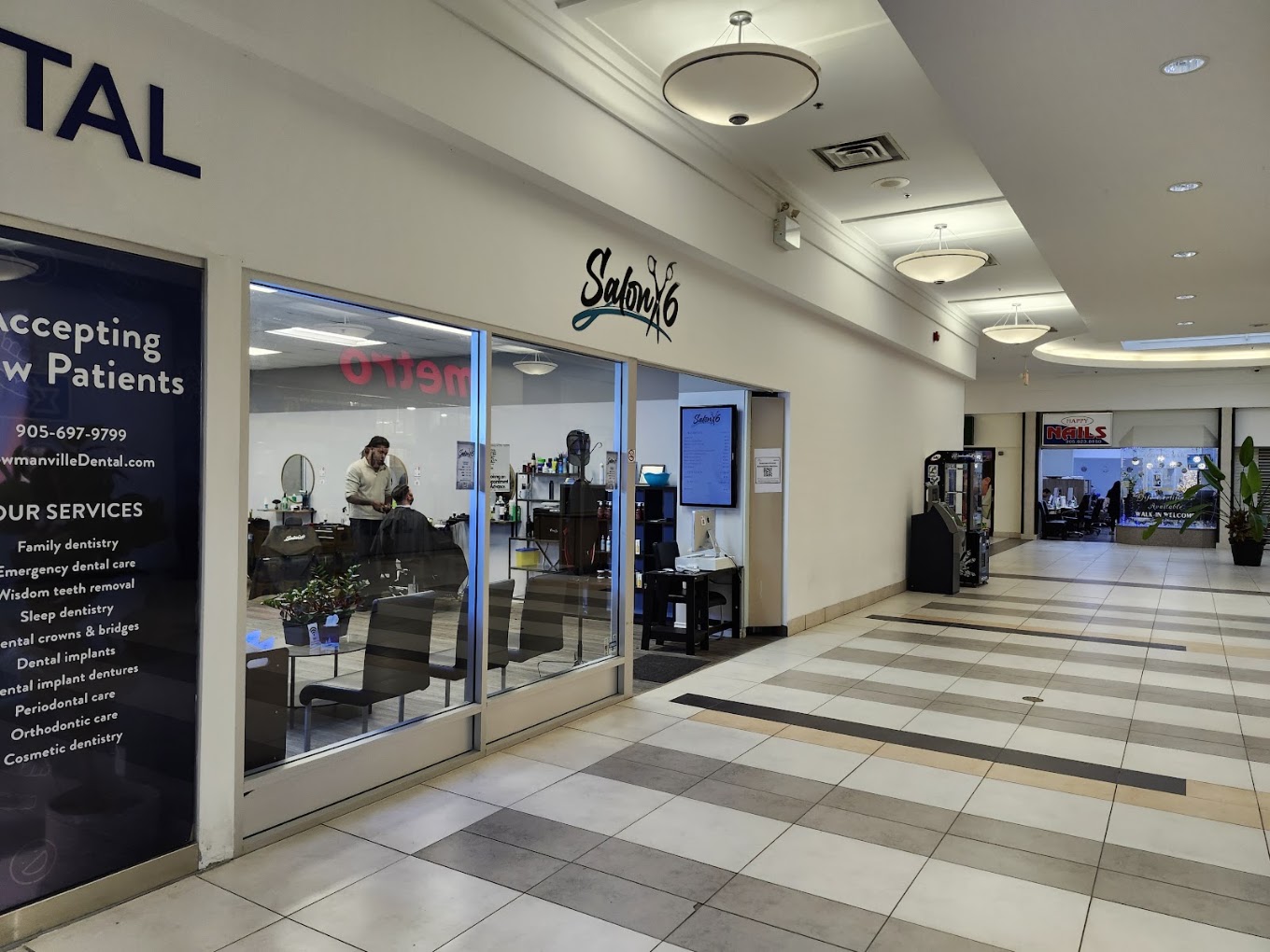 Salon 6 entrance from the Bowmanville Mall corridor with a barber at work